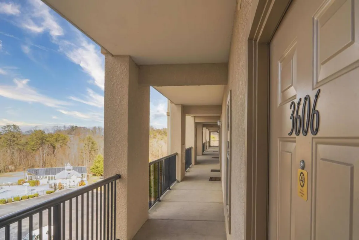 This image features the entrance to Unit 3606 with a clear view of the balcony and a landscaped area beyond. It highlights the welcoming ambiance and the proximity of outdoor spaces just steps from the unit.